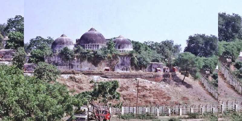 When was the disputed structure demolished in Ayodhya by millions of activists of Hindu organizations?